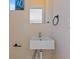 Stylish powder room features a modern vessel sink, sleek fixtures, and a wall-mounted towel ring at 2253 Kipling St, Lakewood, CO 80215