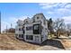 Modern townhome featuring a black and white exterior, balconies, and a contemporary design at 2253 Kipling St, Lakewood, CO 80215