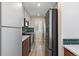 Modern galley kitchen featuring sleek cabinets, stainless steel appliances and a tiled backsplash at 2253 Kipling St, Lakewood, CO 80215
