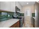 Updated kitchen featuring stainless steel appliances, white countertops, and subway tile backsplash at 2253 Kipling St, Lakewood, CO 80215