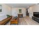 Spacious living area with hardwood floors, comfortable seating, and adjoins dining area at 2253 Kipling St, Lakewood, CO 80215