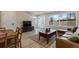 Inviting living room with wood floors, large windows, and a cozy leather sofa and dining set at 2253 Kipling St, Lakewood, CO 80215