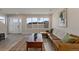 Cozy living area with hardwood floors, modern sofa, and natural light from the large window at 2253 Kipling St, Lakewood, CO 80215