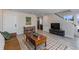 Bright living room with hardwood floors, a leather sofa, and large windows at 2253 Kipling St, Lakewood, CO 80215