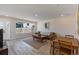 Bright living room with hardwood floors, a leather sofa, and large windows at 2253 Kipling St, Lakewood, CO 80215