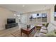 Inviting living room with hardwood floors, modern sofa, dining set and bright natural light at 2253 Kipling St, Lakewood, CO 80215