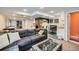 Finished basement featuring a large couch, game table, and a kitchenette at 14096 Roaring Fork Cir, Broomfield, CO 80023