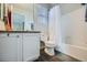 Bathroom with vanity, toilet, and shower-tub combo featuring a white shower curtain at 14096 Roaring Fork Cir, Broomfield, CO 80023