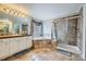 Spacious bathroom featuring a soaking tub, a separate shower, and dual vanities at 14096 Roaring Fork Cir, Broomfield, CO 80023