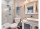 Well-lit bathroom featuring a modern vanity, toilet, and a glass-enclosed shower at 14096 Roaring Fork Cir, Broomfield, CO 80023