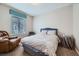 Inviting bedroom with a comfortable bed, recliner, and plenty of natural light at 14096 Roaring Fork Cir, Broomfield, CO 80023