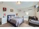 Comfortable bedroom with a full bed, a couch, and personal decor at 14096 Roaring Fork Cir, Broomfield, CO 80023