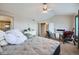 Large bedroom with a comfortable bed, sitting area, and an abundance of natural light at 14096 Roaring Fork Cir, Broomfield, CO 80023