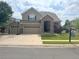 Charming two-story home featuring a stone-accented entrance, spacious three-car garage, and well-maintained front lawn at 14096 Roaring Fork Cir, Broomfield, CO 80023