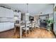 Open concept kitchen and dining area featuring white cabinets, desk area and hardwood floors at 14096 Roaring Fork Cir, Broomfield, CO 80023