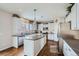 Contemporary kitchen features a center island, stainless appliances, and white cabinetry at 14096 Roaring Fork Cir, Broomfield, CO 80023
