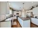 Modern kitchen with white cabinets, a center island, granite countertops and stainless steel appliances at 14096 Roaring Fork Cir, Broomfield, CO 80023
