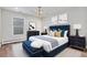 Bedroom featuring a stylish bed, modern lighting, and wood flooring at 10150 E Virginia Ave # 7-304, Denver, CO 80247