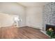 Open-concept living area features a decorative stone fireplace, and an adjacent kitchen area at 10150 E Virginia Ave # 7-304, Denver, CO 80247
