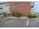 Exterior view of the parking lot showcases the building's brick and siding facade at 10150 E Virginia Ave # 7-304, Denver, CO 80247