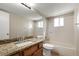 Bathroom featuring a granite vanity, large mirror, and a shower-tub combination at 11519 Wray Ct, Parker, CO 80134