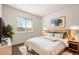 Bright bedroom with wood floors, modern decor, a large window, and a neutral color scheme at 11519 Wray Ct, Parker, CO 80134