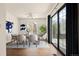 Stylish dining area features modern table, art, patio access, and bright natural light at 11519 Wray Ct, Parker, CO 80134