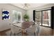 Stylish dining area with modern lighting, seating for six, and sliding glass doors at 11519 Wray Ct, Parker, CO 80134