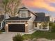 Attractive two-story home with stone accents, a two-car garage, and lush green lawn at 11519 Wray Ct, Parker, CO 80134