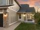Close-up of the home's entrance with a stone pillar accent, a bench, and a well-manicured lawn at sunset at 11519 Wray Ct, Parker, CO 80134