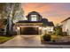 Inviting two-story home with a two-car garage, stone accents, and manicured landscaping in the evening at 11519 Wray Ct, Parker, CO 80134
