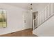 Bright foyer with wood floors, a white staircase, and a front door with glass panels, illuminated by a modern pendant light at 11519 Wray Ct, Parker, CO 80134