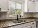 Close up of the kitchen area with granite countertops and a modern sink at 11519 Wray Ct, Parker, CO 80134