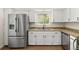 Bright kitchen features stainless steel refrigerator, granite countertops, and modern sink at 11519 Wray Ct, Parker, CO 80134