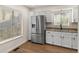 Bright kitchen features stainless steel refrigerator, granite countertops, and modern sink at 11519 Wray Ct, Parker, CO 80134