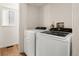 Bright laundry area with new white washer and dryer units and a window for natural light at 11519 Wray Ct, Parker, CO 80134