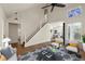 Comfortable living room with a staircase, views into other rooms, and contemporary furnishings at 11519 Wray Ct, Parker, CO 80134