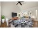 Bright living room featuring modern furniture, large windows, and hardwood floors at 11519 Wray Ct, Parker, CO 80134