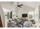 Inviting living room featuring a high ceiling, large windows, and stylish furnishings at 11519 Wray Ct, Parker, CO 80134