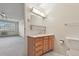 Bathroom featuring vanity and mirror, with view into the adjacent bedroom at 9625 E Center Ave # 5C, Denver, CO 80247