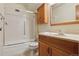 Bathroom featuring tub and shower combo, vanity, and mirrored cabinet at 9625 E Center Ave # 5C, Denver, CO 80247