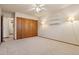 Spacious bedroom with carpet, ceiling fan, and ample closet space at 9625 E Center Ave # 5C, Denver, CO 80247