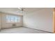 Well-lit bedroom featuring neutral carpeting, a ceiling fan, and a window with blinds at 9625 E Center Ave # 5C, Denver, CO 80247