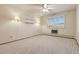 Bright bedroom with ceiling fan, shelves, and window with shutter style blinds at 9625 E Center Ave # 5C, Denver, CO 80247