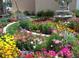 Beautiful landscaped garden with flowers of many colors and water fountain at 9625 E Center Ave # 5C, Denver, CO 80247