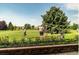 Golf course view showcasing players on the green with lush grass and mature trees at 9625 E Center Ave # 5C, Denver, CO 80247