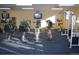 Well-equipped gym featuring various exercise machines and wall-mounted TVs at 9625 E Center Ave # 5C, Denver, CO 80247