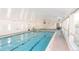 Indoor swimming pool with bright light from surrounding windows at 9625 E Center Ave # 5C, Denver, CO 80247