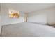 Spacious living room with neutral carpet and a view into the kitchen at 9625 E Center Ave # 5C, Denver, CO 80247