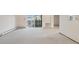 Open living room with sliding door to covered porch and wall-mounted heater at 9625 E Center Ave # 5C, Denver, CO 80247